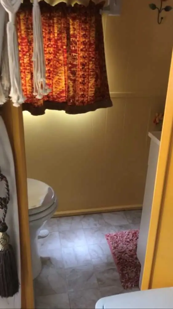 Begonia private bathroom with yellow wood paneling – Begonia Vintage Camper at The Outpost NRG