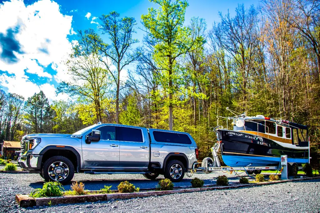 Truck and boat trailer at a full hookup RV site – Full Hookup RV Site at The Outpost NRG
