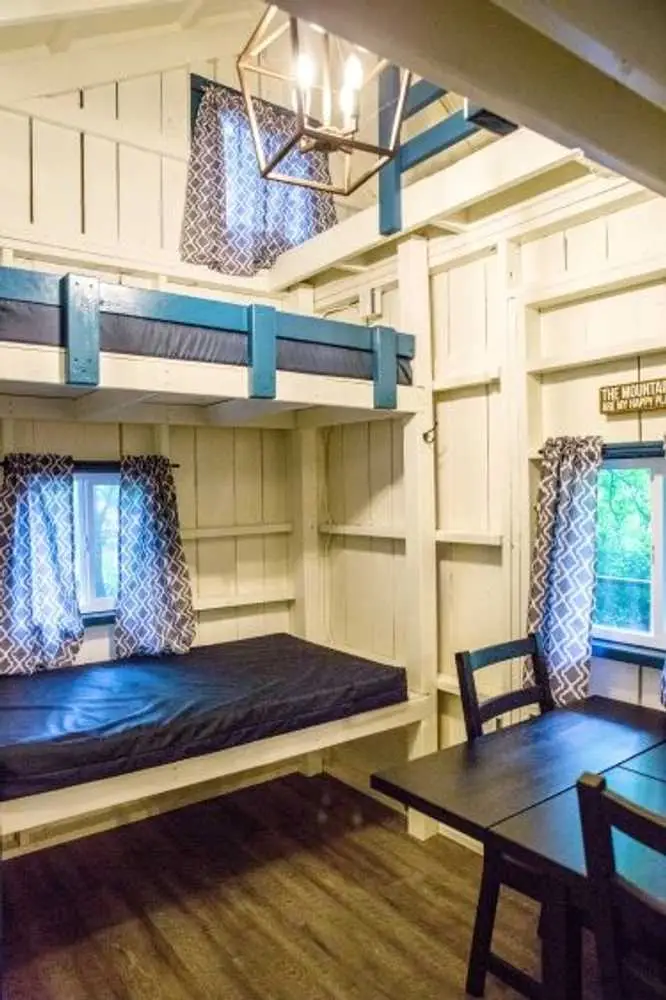 Bunk beds by the window in the Big Family Cabin – Rustic Big Family Cabin at The Outpost NRG