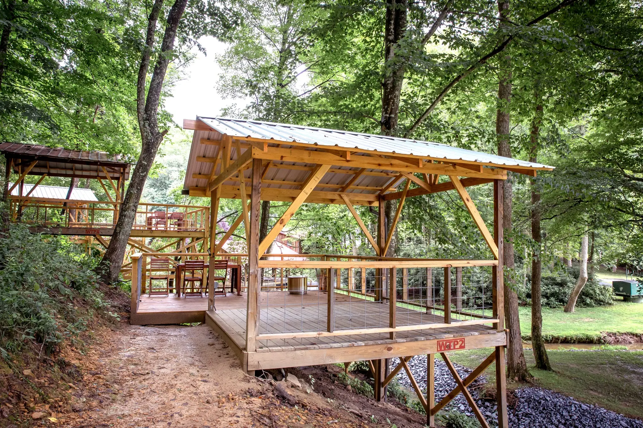 Covered wooden tent platforms in the trees – Tent Platforms at The Outpost NRG