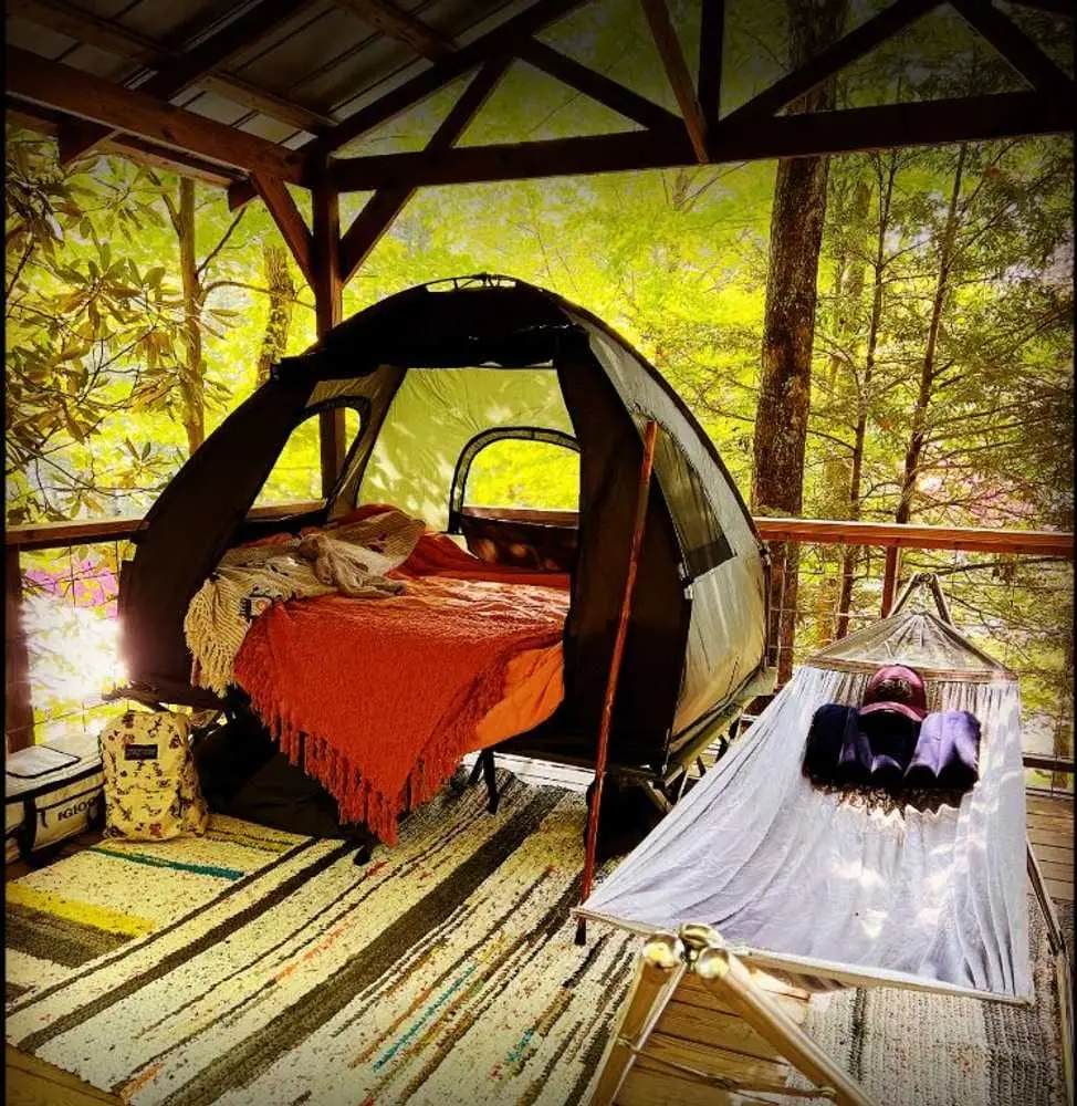 Cozy tent platform setup with hammock and fire pit – Tent Platforms at The Outpost NRG