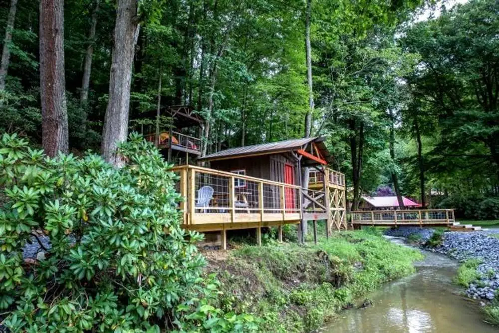 Bunk cabin deck overlooking the creek – Rustic Bunk Cabin at The Outpost NRG