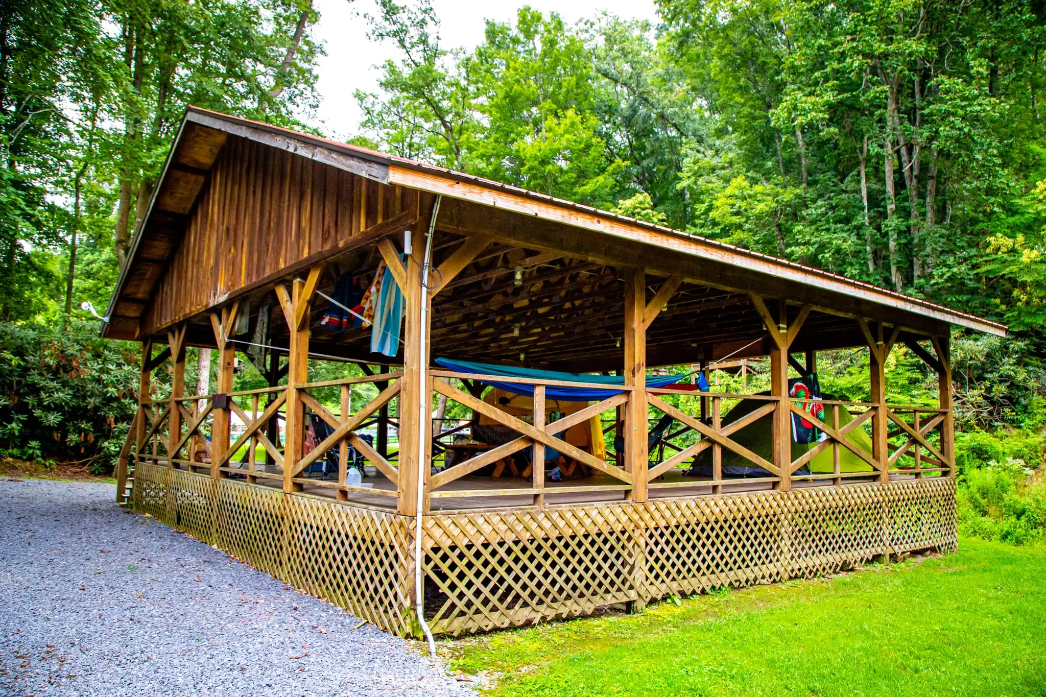 Open-sided tent pavilion on a raised wooden deck – Tent Pavilion at The Outpost NRG
