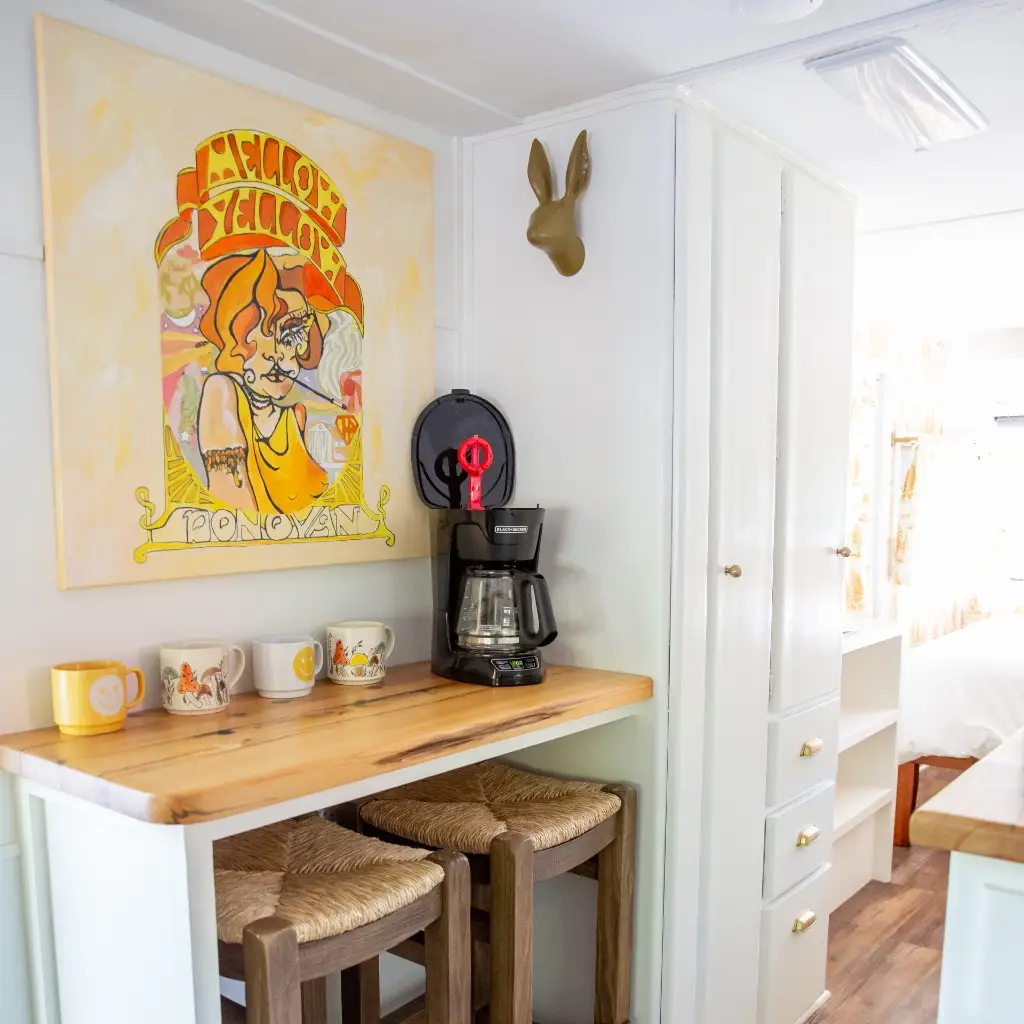 Mellow Yellow sunshine-themed dining nook with woven seating – Mellow Yellow Vintage Camper at The Outpost NRG