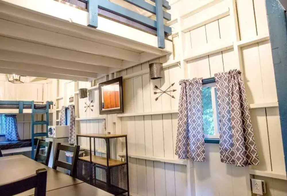 Dining table and kitchenette in the Big Family Cabin – Rustic Big Family Cabin at The Outpost NRG