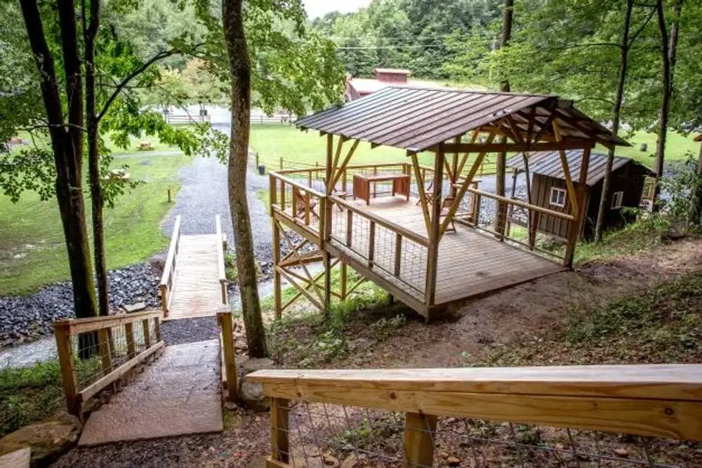 Elevated view of tent platforms and wooden walkway – Tent Platforms at The Outpost NRG