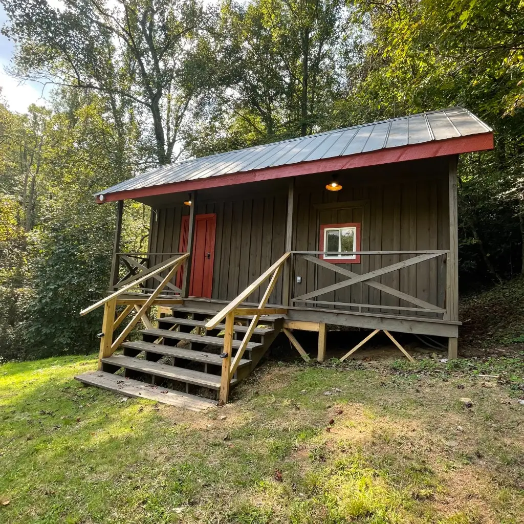 Rustic Big Family Cabin with porch and red trim – Rustic Big Family Cabin at The Outpost NRG