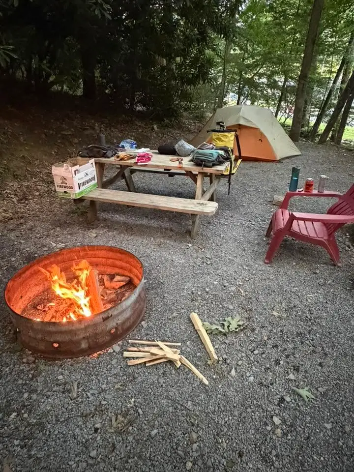 Tent site with fire pit, picnic table, and tent – Tent Sites at The Outpost NRG