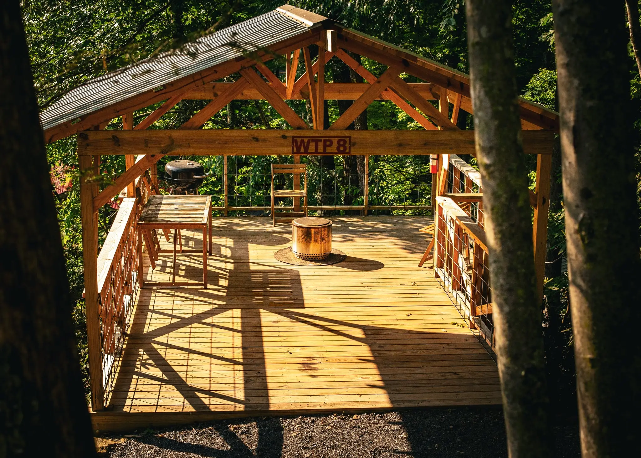 Fire pit beside a tent platform – Tent Platforms at The Outpost NRG
