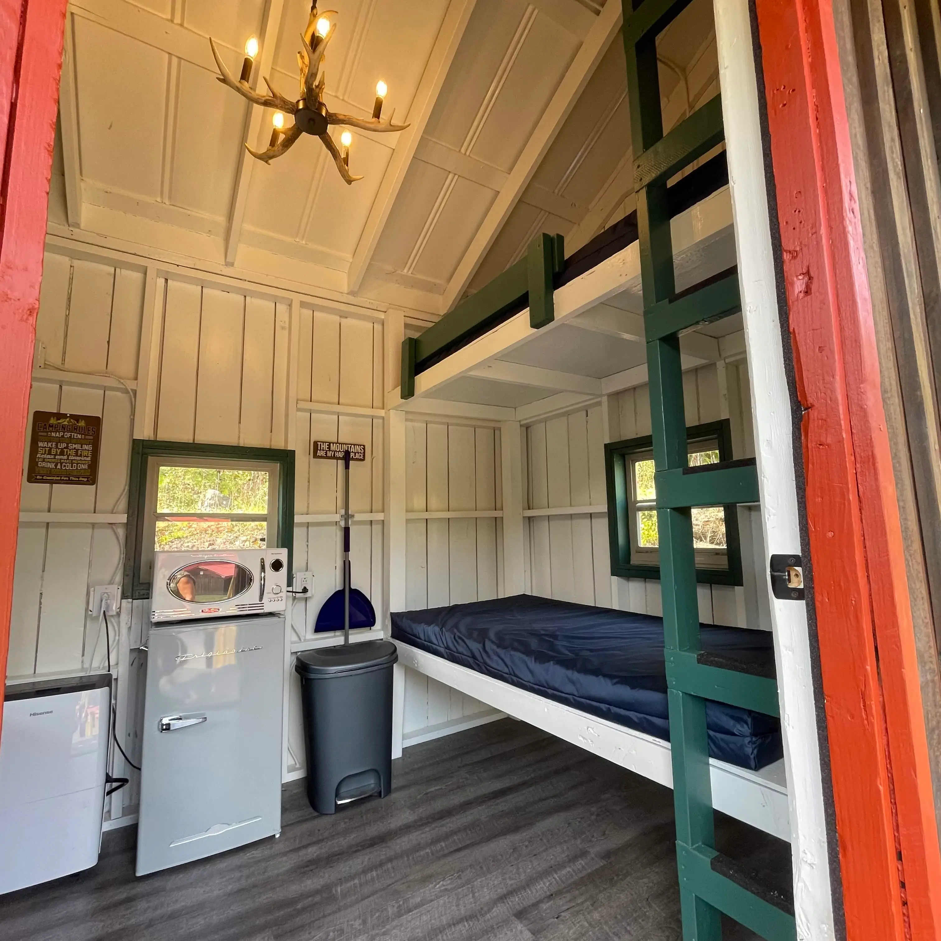 Rustic Bunk Cabin interior with bunk mattresses – Rustic Bunk Cabin at The Outpost NRG