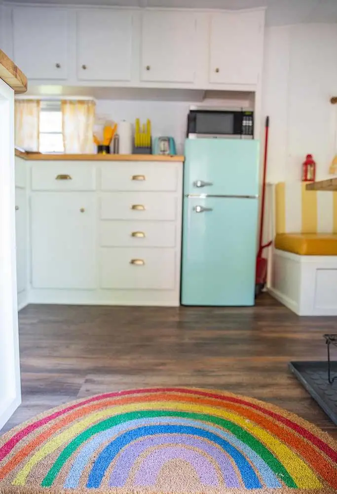 Mellow Yellow kitchen entry with patterned rug – Mellow Yellow Vintage Camper at The Outpost NRG