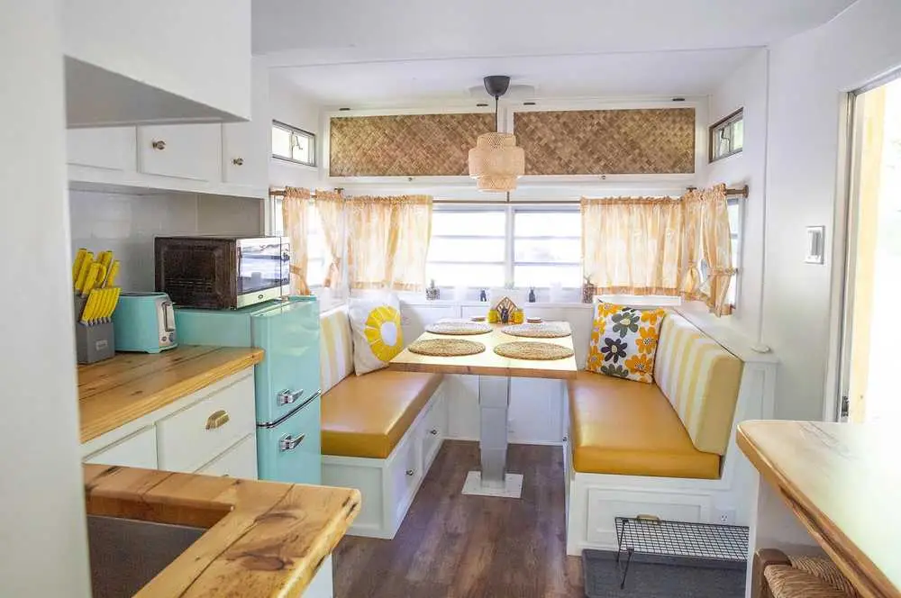 Mellow Yellow living and dining area with sunshine decor – Mellow Yellow Vintage Camper at The Outpost NRG