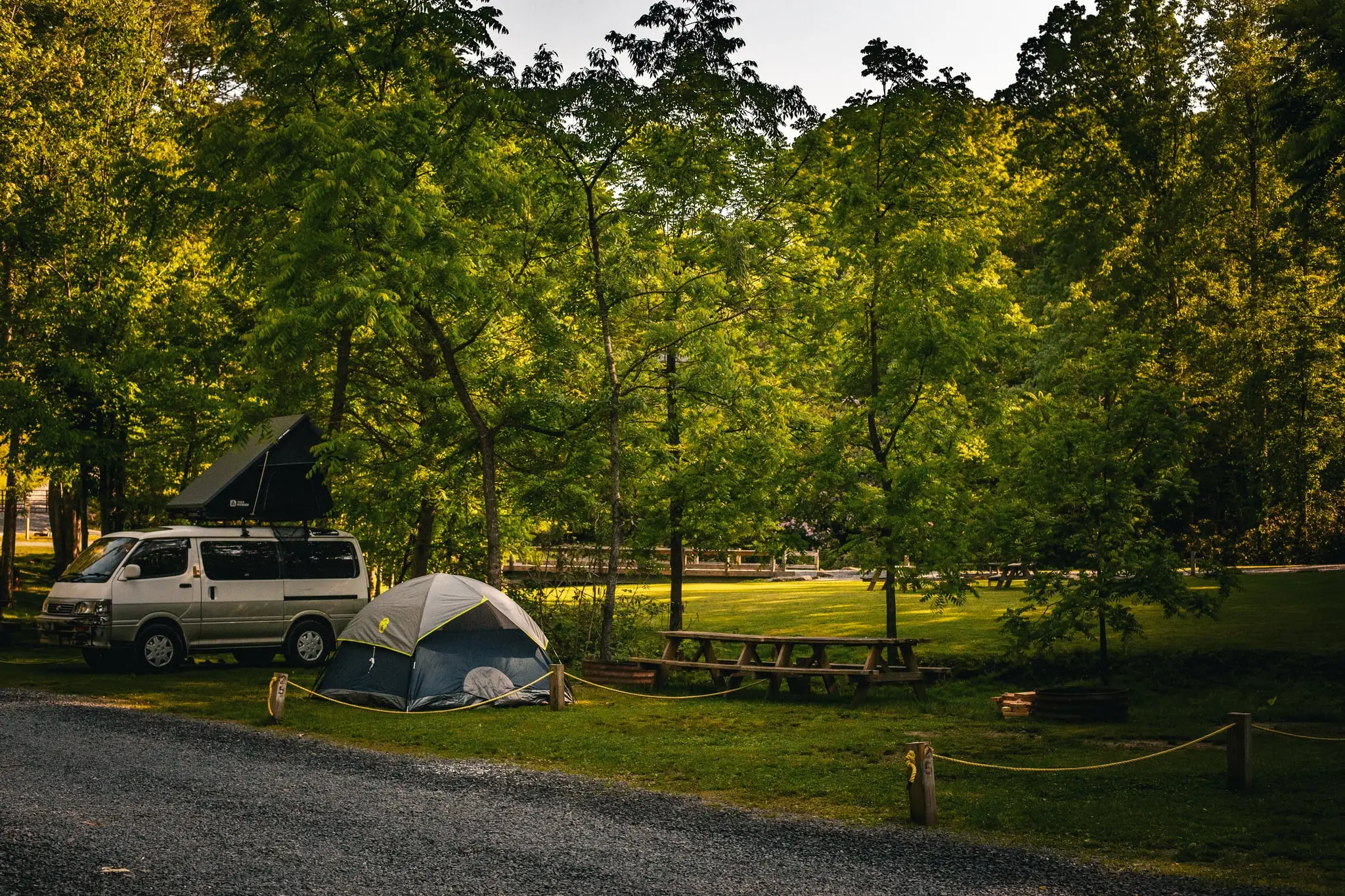 Creek-side Lower Outpost campsite with fire pit – Tent Sites at The Outpost NRG