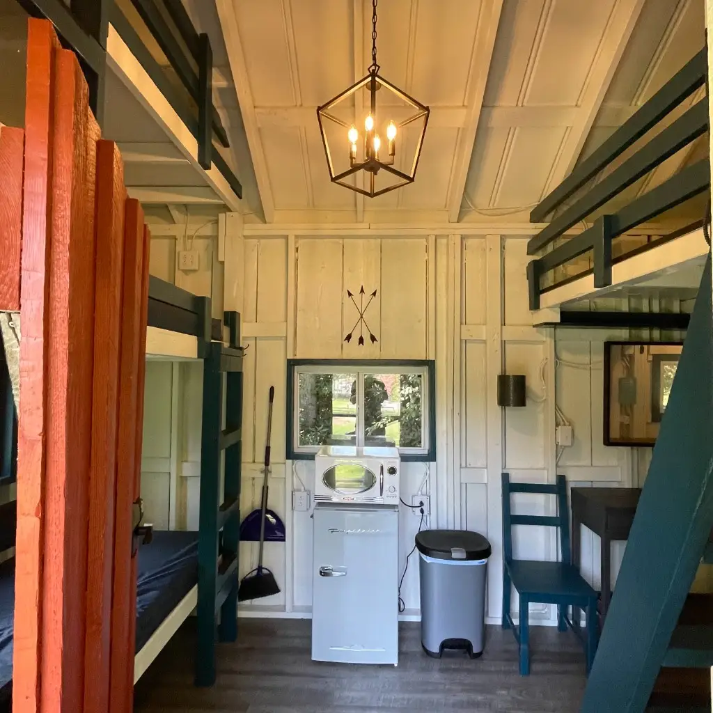 Rustic Big Family Cabin main room with bunks and kitchenette – Rustic Big Family Cabin at The Outpost NRG