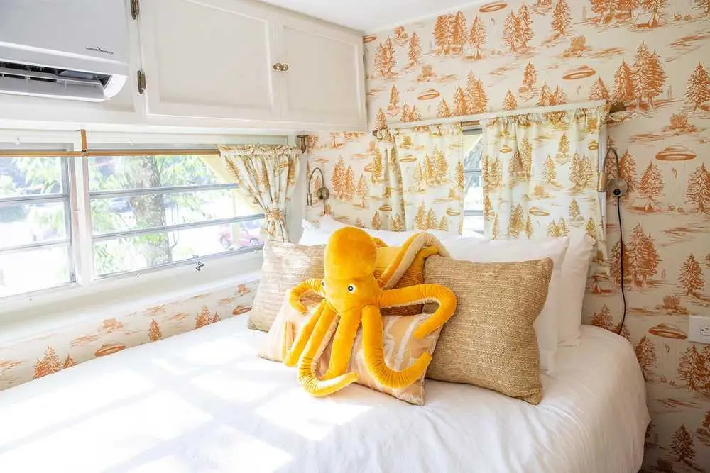 Mellow Yellow master bedroom with alien abduction wallpaper – Mellow Yellow Vintage Camper at The Outpost NRG