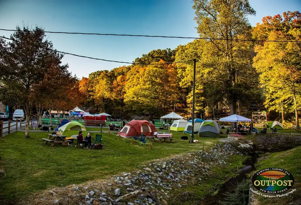 Tents beside a picnic table at sunrise – Tent Sites at The Outpost NRG