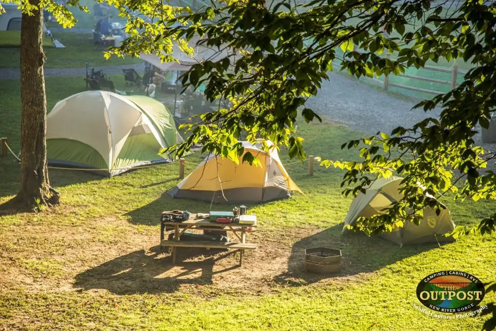 Tents and picnic table in morning light at the Upper Outpost – Tent Sites at The Outpost NRG