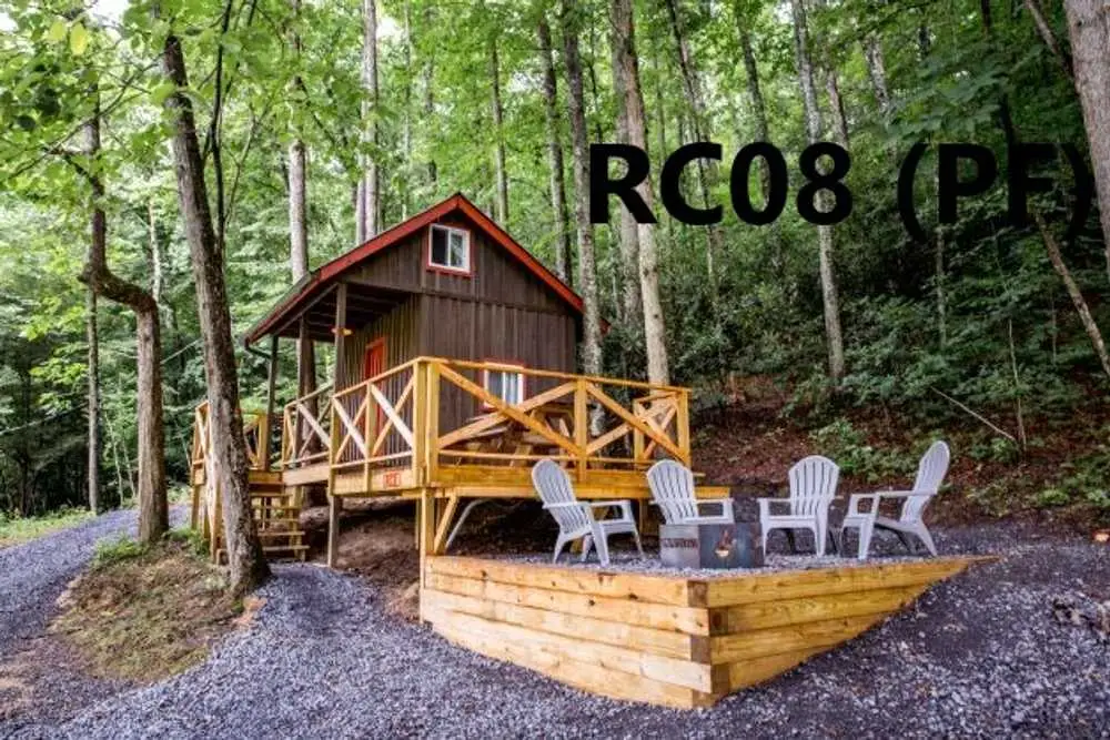 Creekside patio with fire pit and Adirondack chairs – Rustic Family Cabin at The Outpost NRG