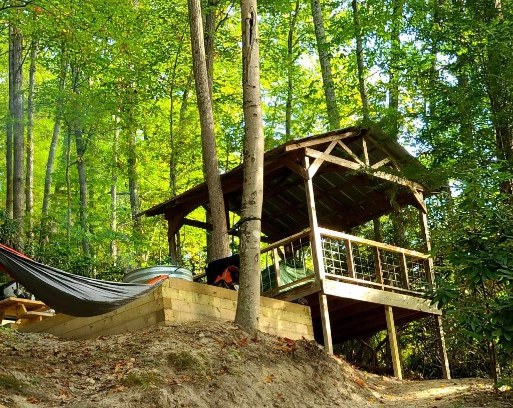 Wooden tent platform pavilion with hammock in the forest – Tent Platforms at The Outpost NRG