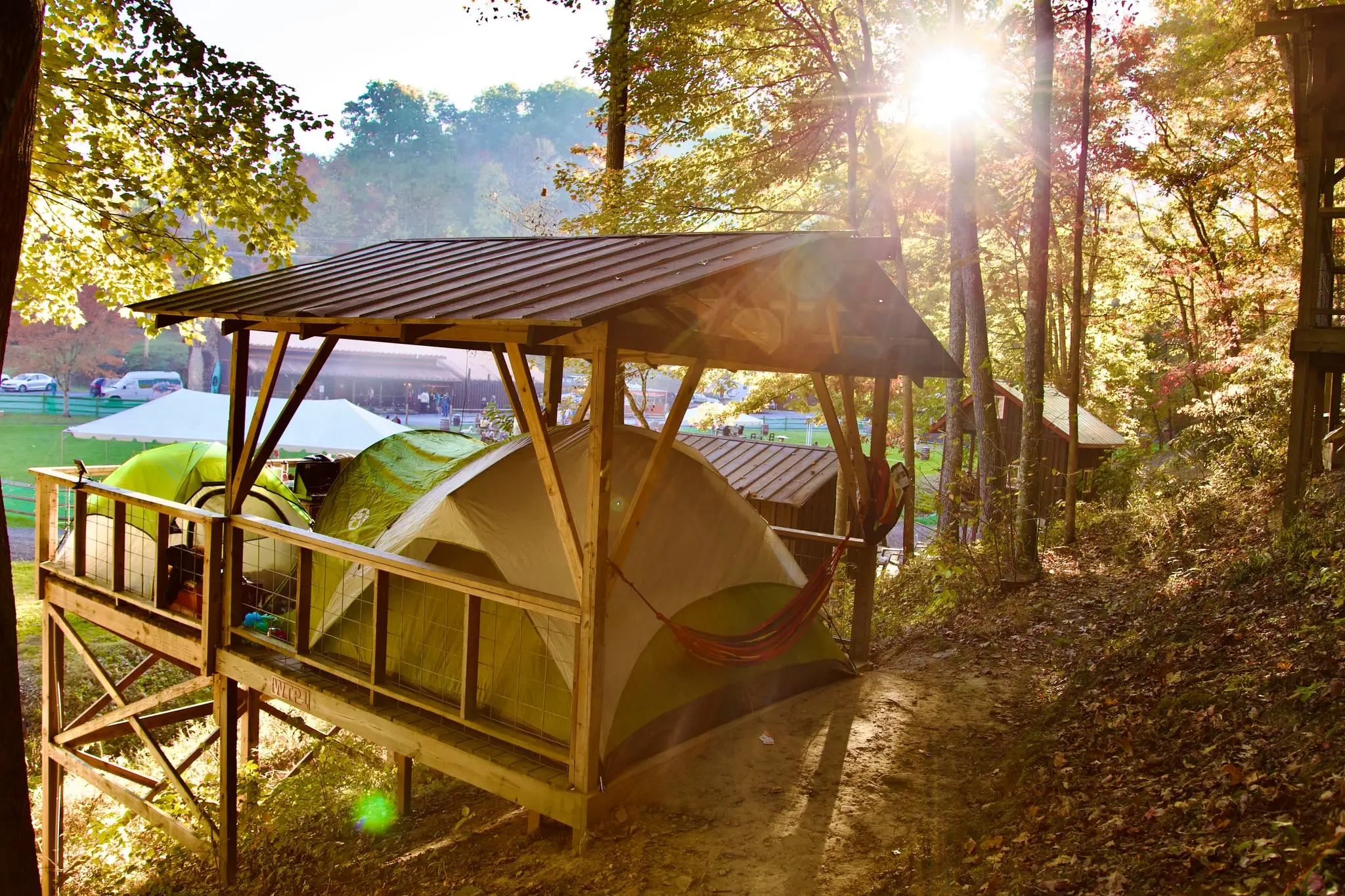 Camping tents set up on a wooded platform – Tent Platforms at The Outpost NRG