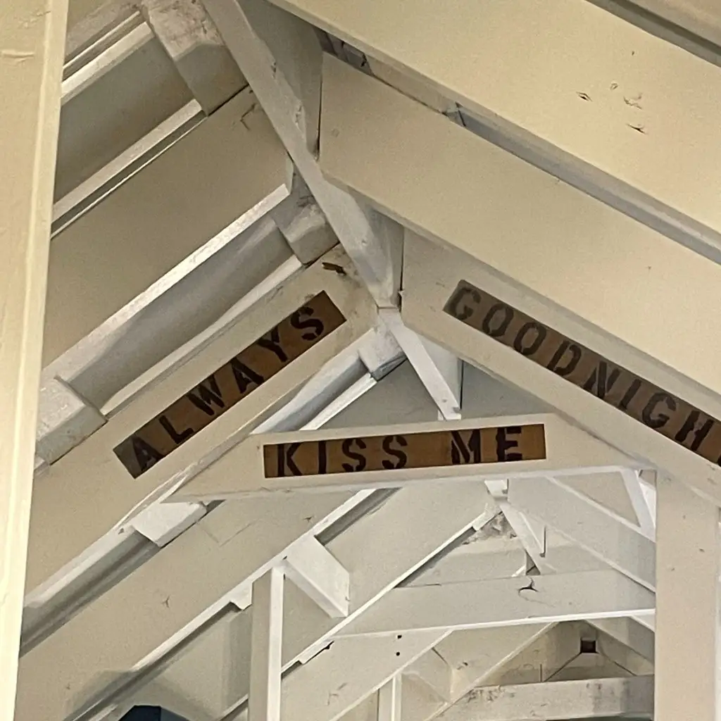 Stenciled rafters reading Always Kiss Me Goodnight – Rustic Big Family Cabin at The Outpost NRG