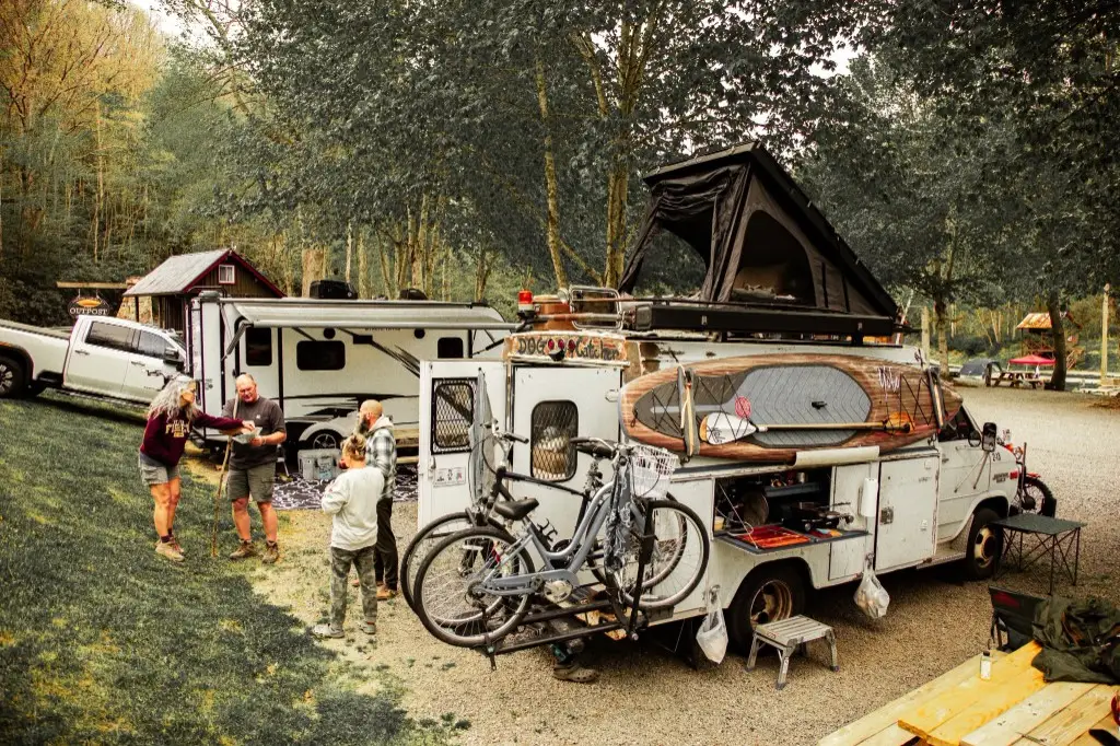 Family camping with a rooftop-tent van at the partial hookup lot – Partial Hookup RV Site at The Outpost NRG
