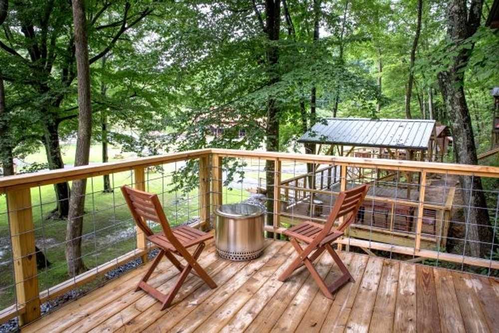 Chairs and fire pit on a tent platform deck – Tent Platforms at The Outpost NRG
