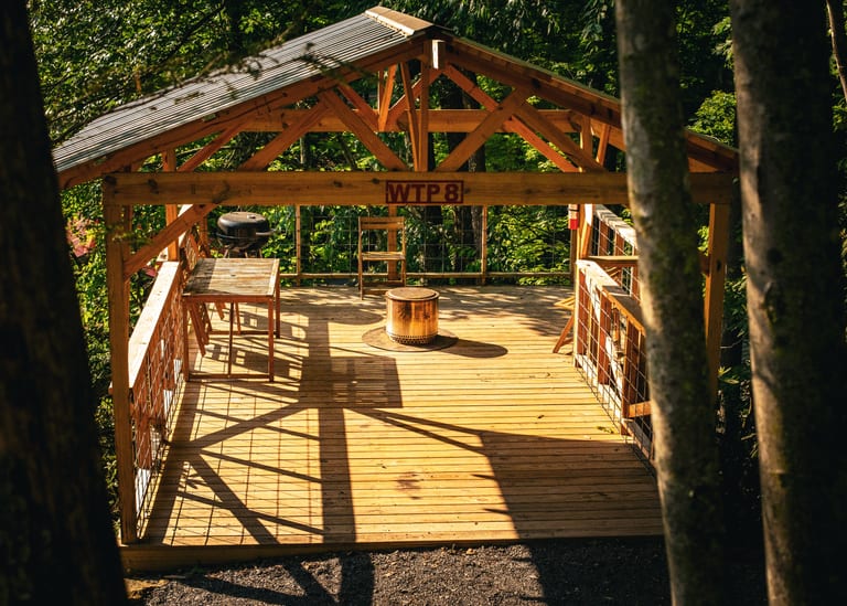 Fire pit beside a tent platform – Tent Platforms at The Outpost NRG