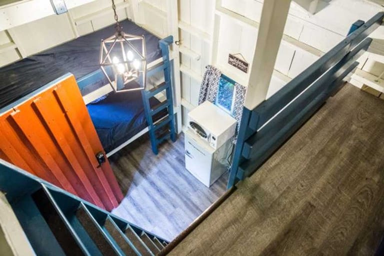 View from the loft overlooking the main room – Rustic Big Family Cabin at The Outpost NRG