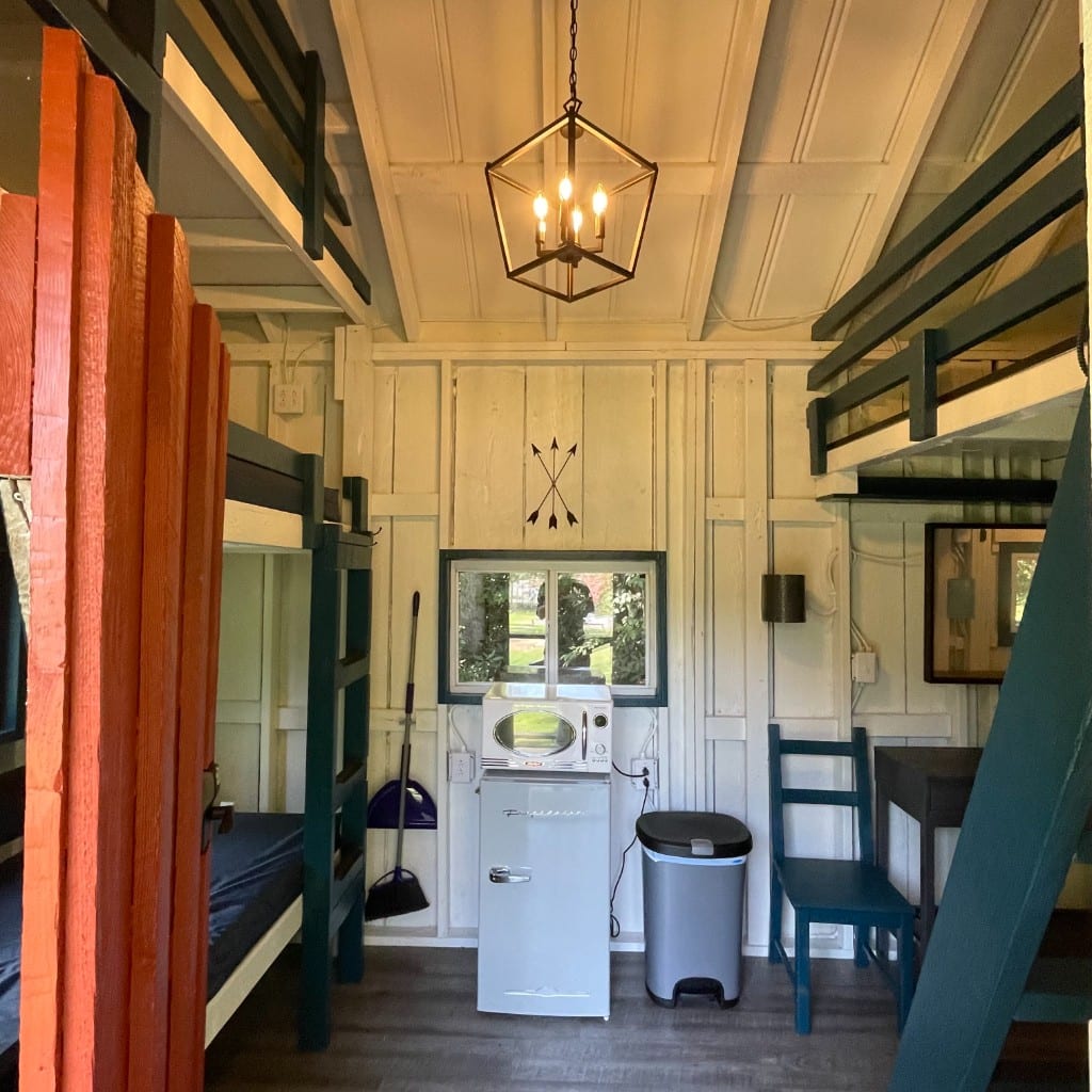 Rustic Big Family Cabin main room with bunks and kitchenette – Rustic Big Family Cabin at The Outpost NRG