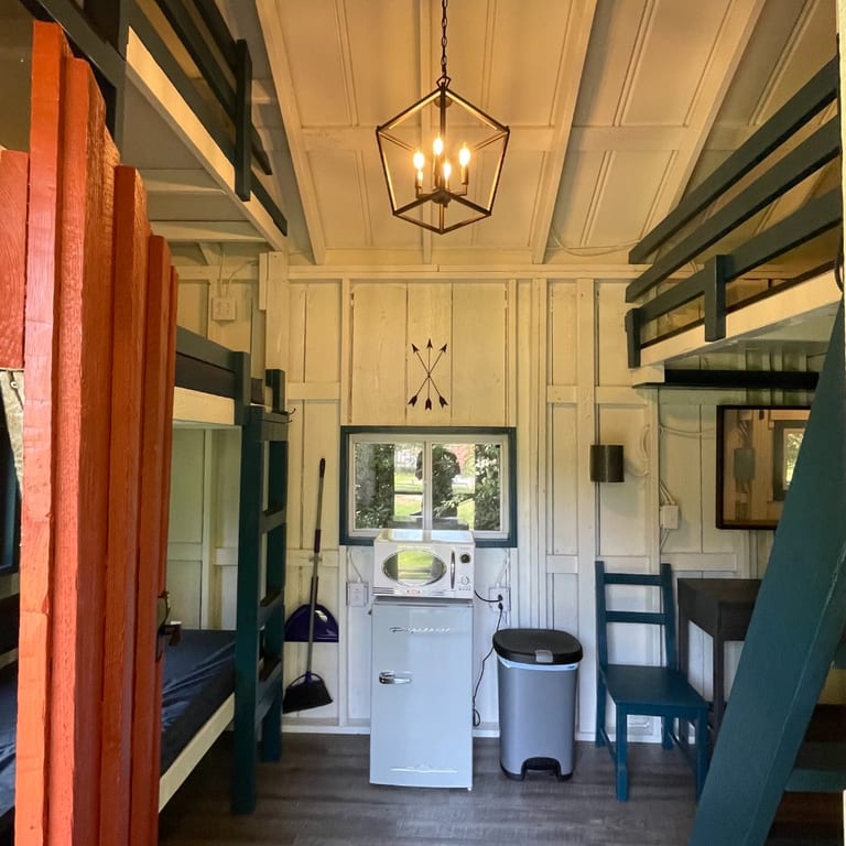Rustic Big Family Cabin main room with bunks and kitchenette – Rustic Big Family Cabin at The Outpost NRG