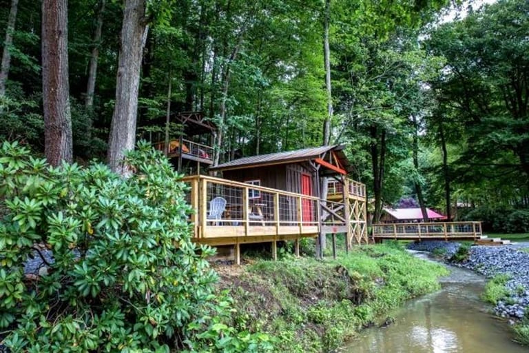 Bunk cabin deck overlooking the creek – Rustic Bunk Cabin at The Outpost NRG